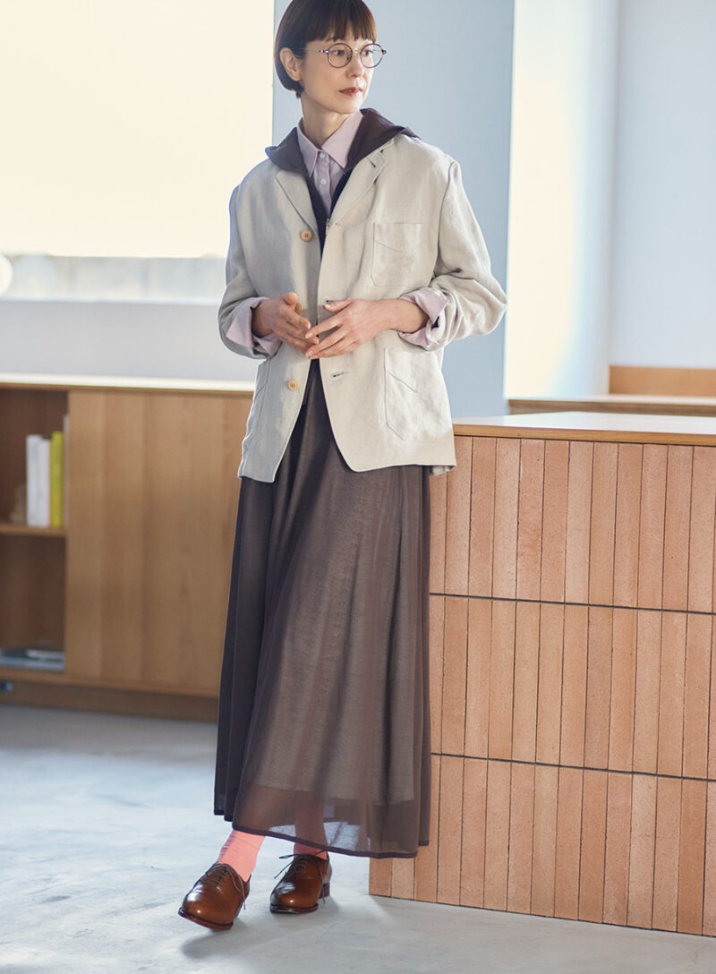 ジャケット¥74,800/ナイジェル・ケーボンウーマン( アウターリミッツ)、メガネ¥19,800/ザ ベッドフォード ホテル(キングスター)、パーカ¥12,100、シャツ¥16,500/ともにノーク、スカート¥35,200/アンフィル、シューズ¥39,600/ジャランスリウァヤ(ジャランスリウァヤ 日本橋)